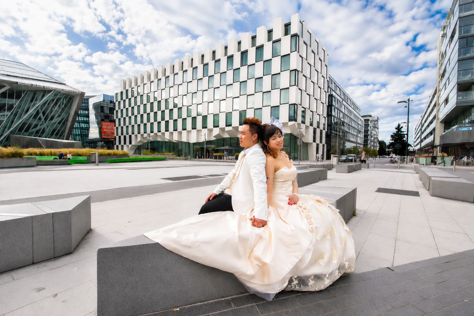Kenzo and May beneath a bright sky in Grand Canal Square