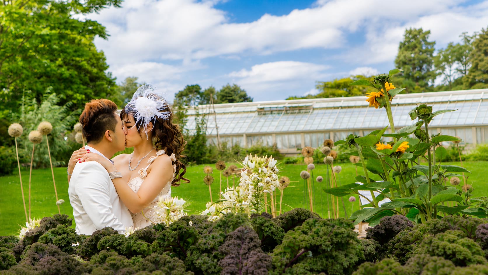 Kenzo and May kissing in a flower garden