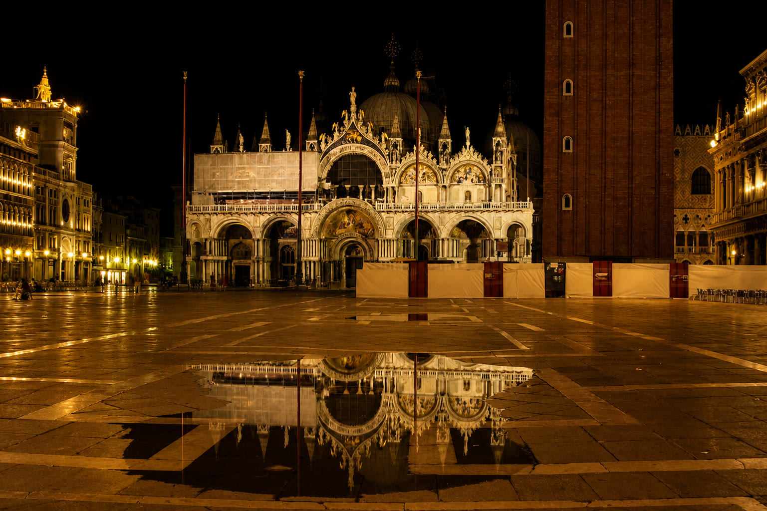 St Mark's Basilica reflected in rainwater at night in Venice